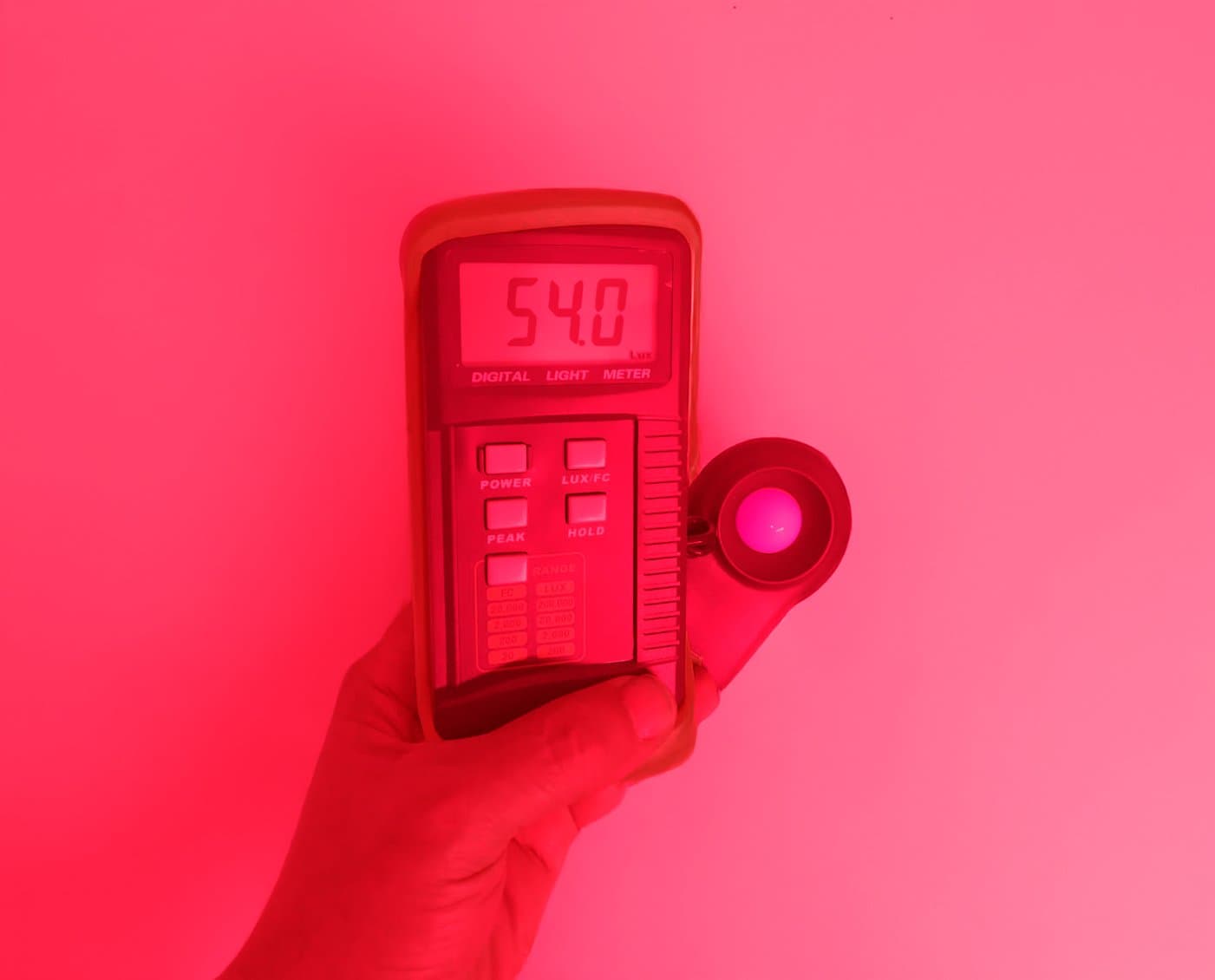 Luxmeter reading 54 lux from red LED strip in mining tunnel
